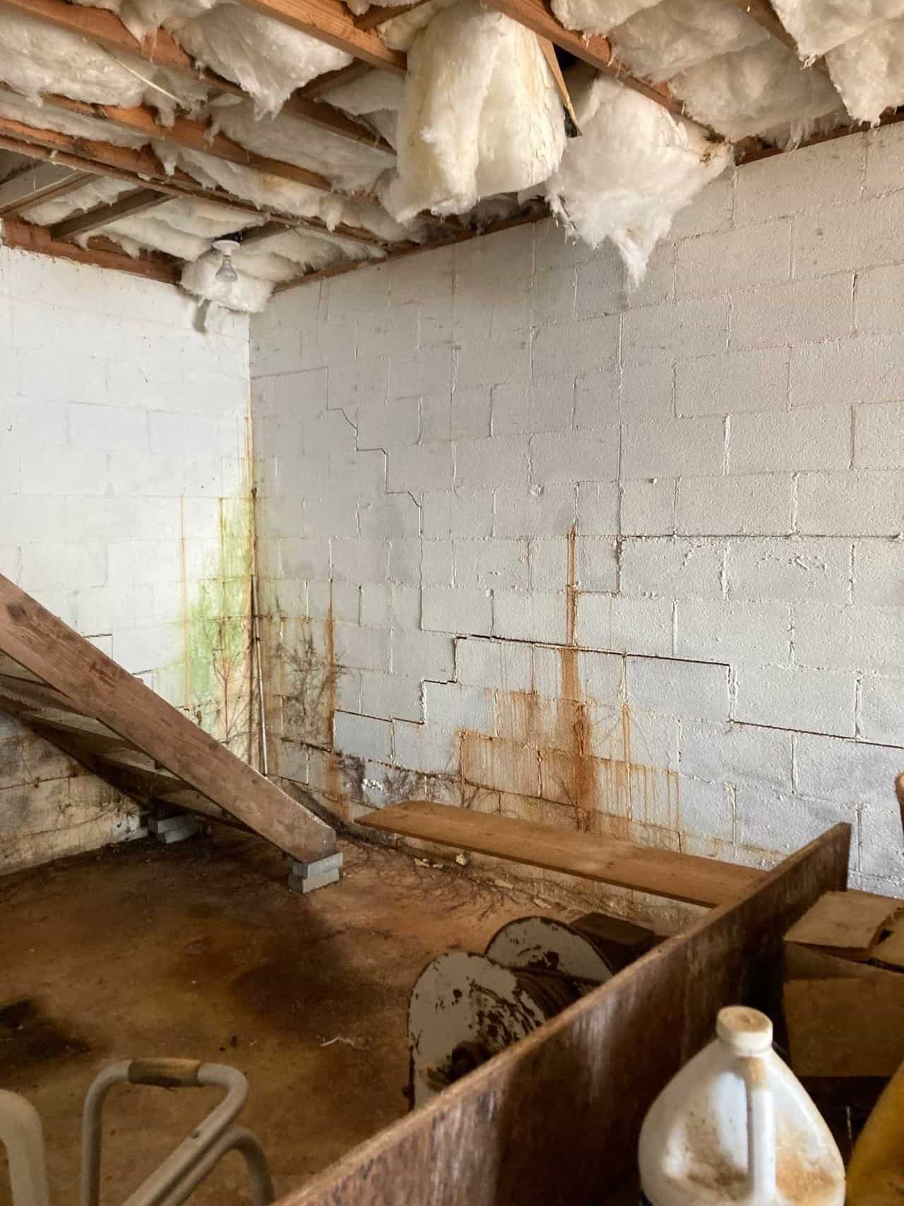 HydroHelp911 Crawl Space & Foundation Repair inspecting a basement with stair step masonry cracks, wall seepage