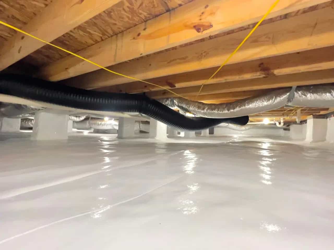 HydroHelp911 Crawl Space & Foundation Repair installing a white crawl space vapor barrier.