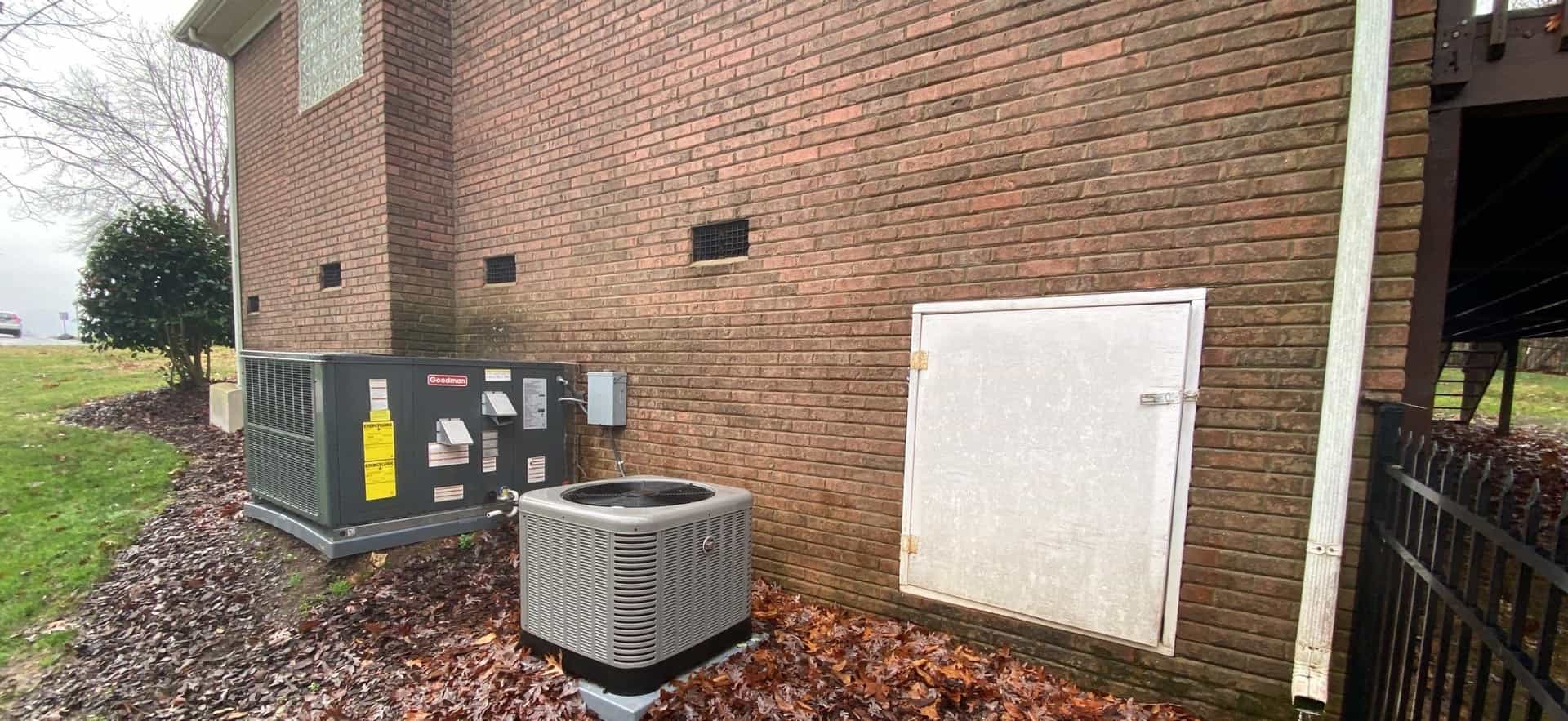 HydroHelp911 Crawl Space & Foundation Repair inspecting an exterior brick foundation with improper drainage