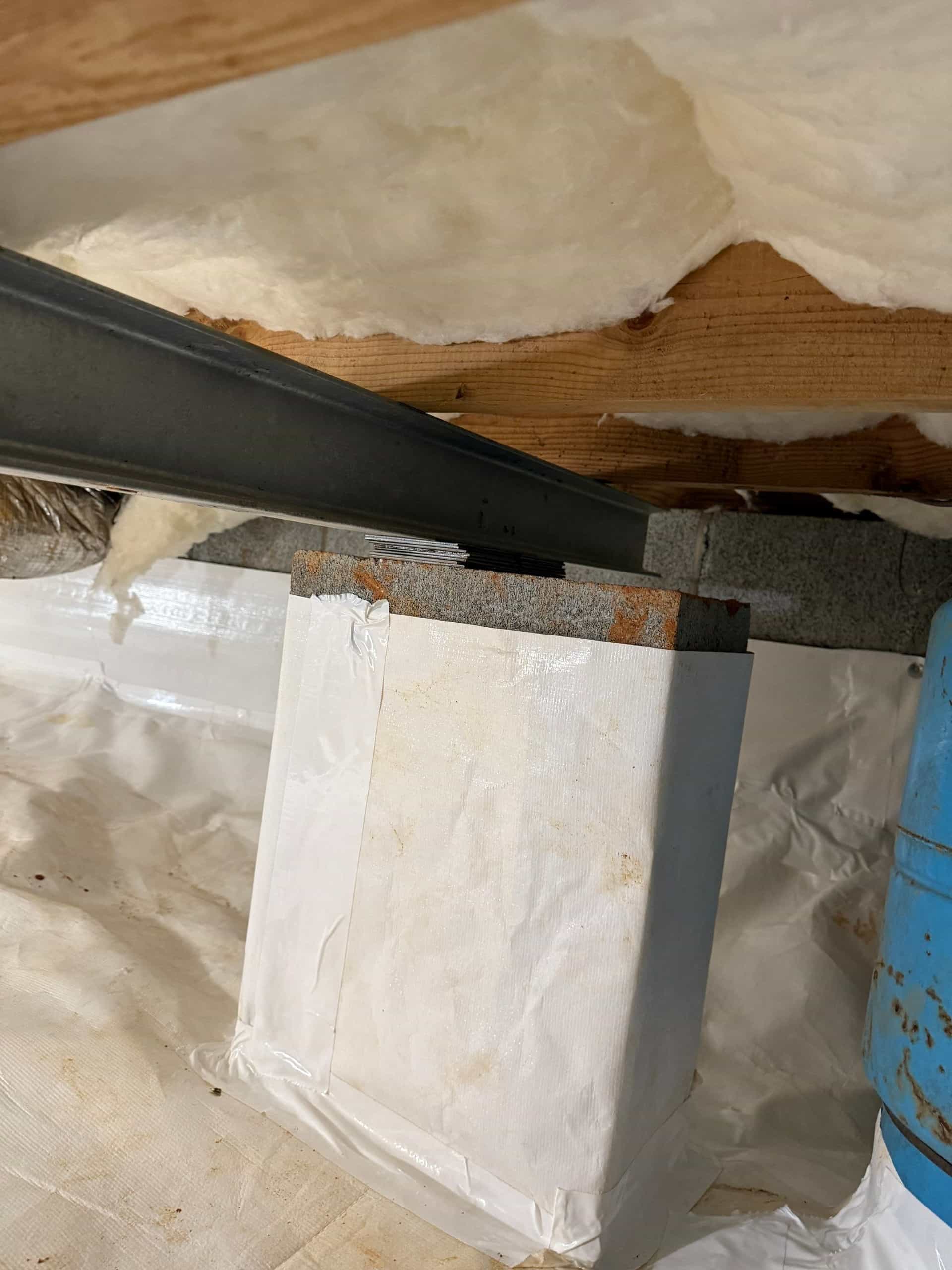 HydroHelp911 Crawl Space & Foundation Repair installing insulation and a vapor barrier in a crawl space with exposed joists.
