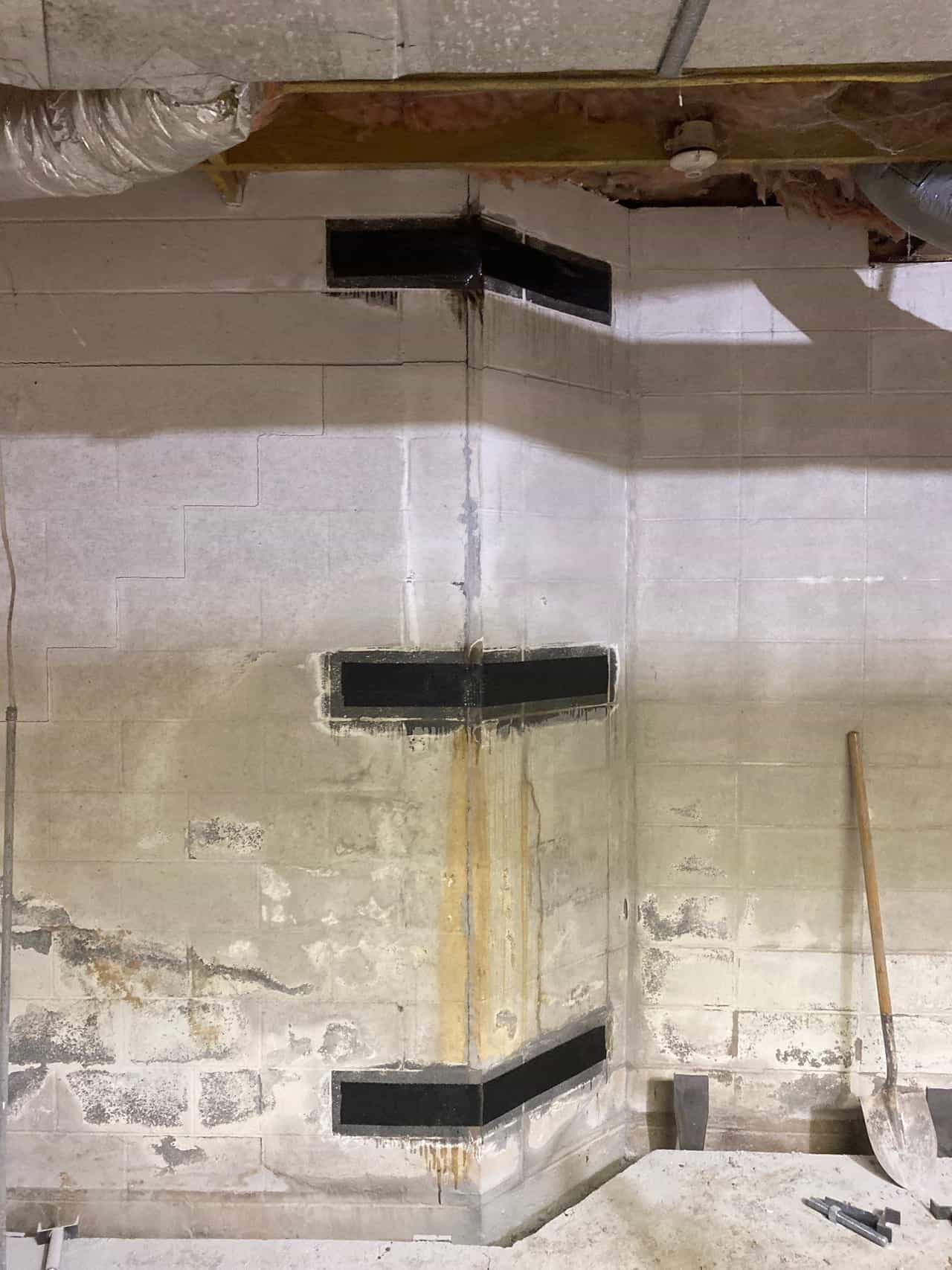HydroHelp911 Crawl Space & Foundation Repair applying carbon fiber reinforcement to a bowing basement wall