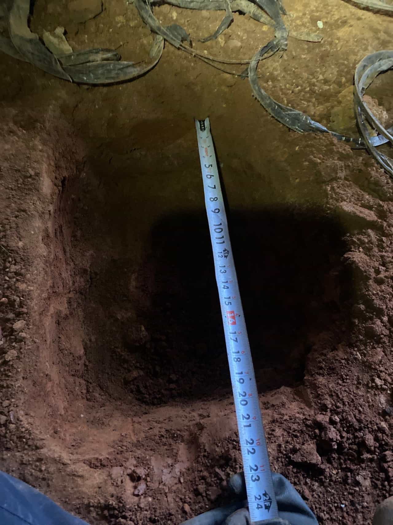 HydroHelp911 Crawl Space & Foundation Repair measuring an excavation for post and pier replacement.