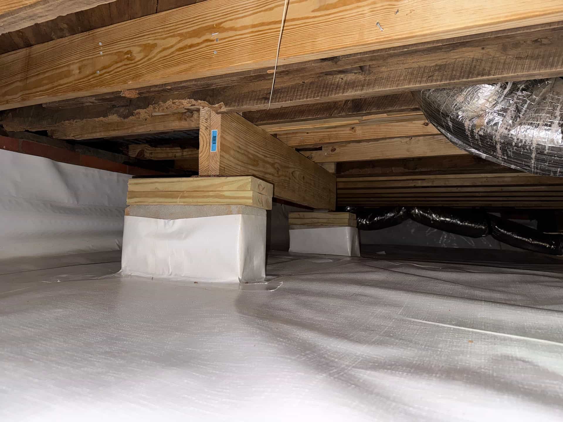 HydroHelp911 Crawl Space & Foundation Repair installing crawl space support jacks under a vapor barrier
