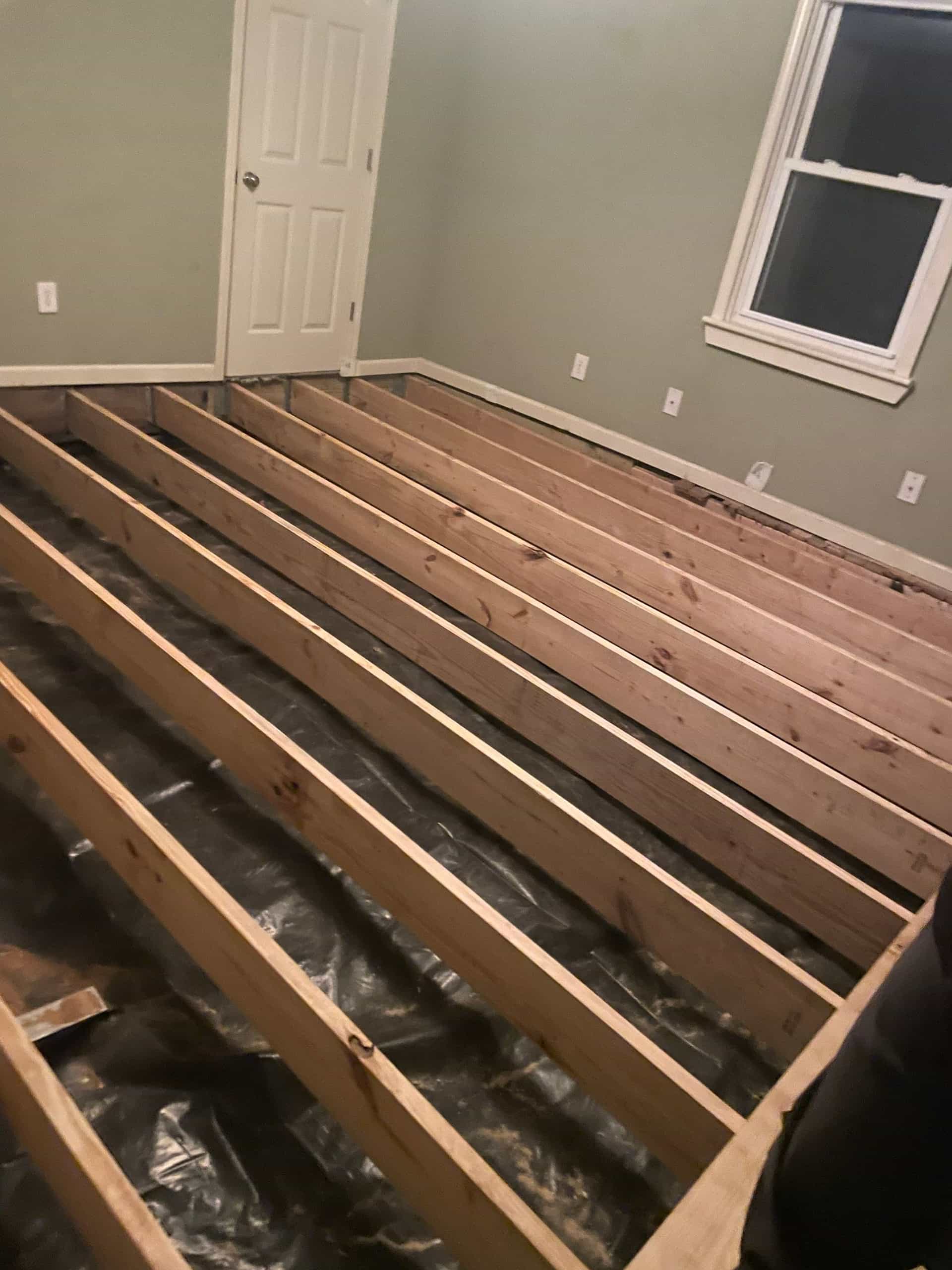 HydroHelp911 Crawl Space & Foundation Repair crew installing new floor joists during a structural repair.