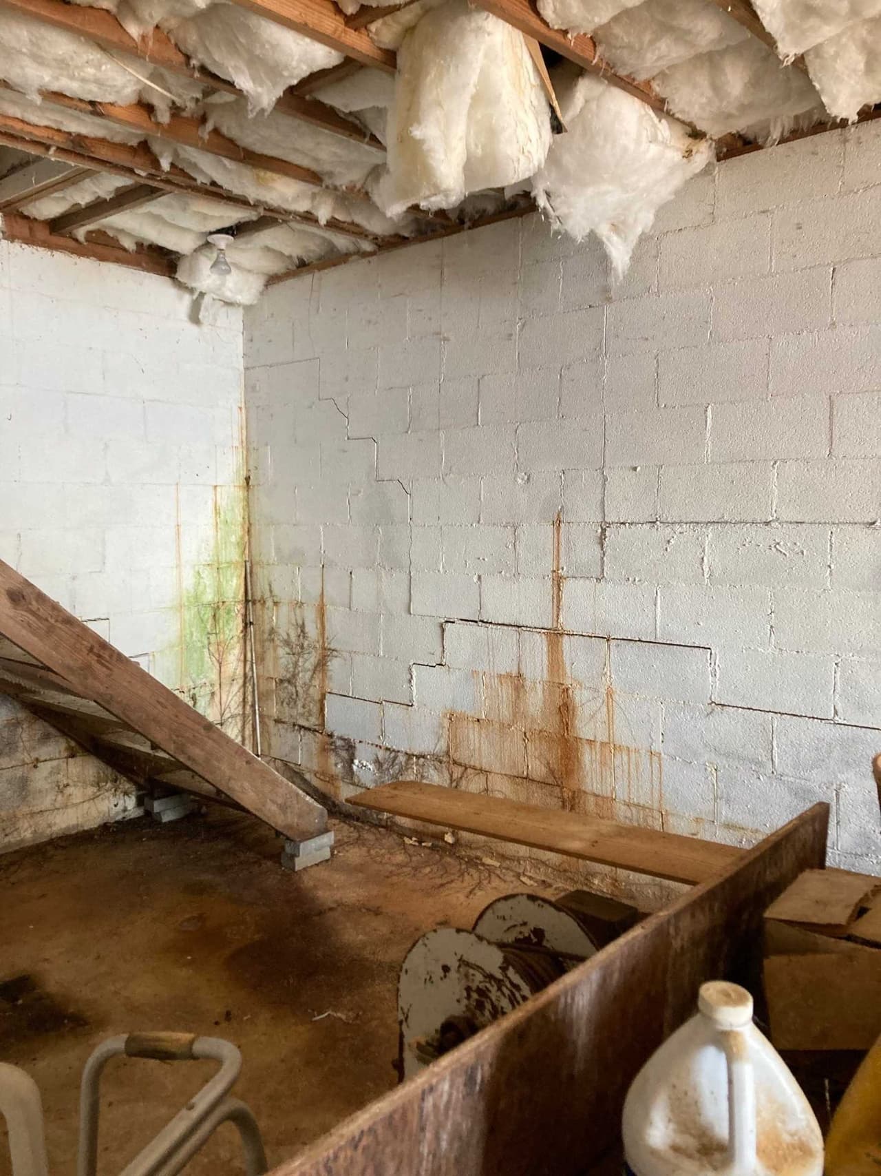 HydroHelp911 Crawl Space & Foundation Repair inspecting a basement with stair step masonry cracks, wall seepage