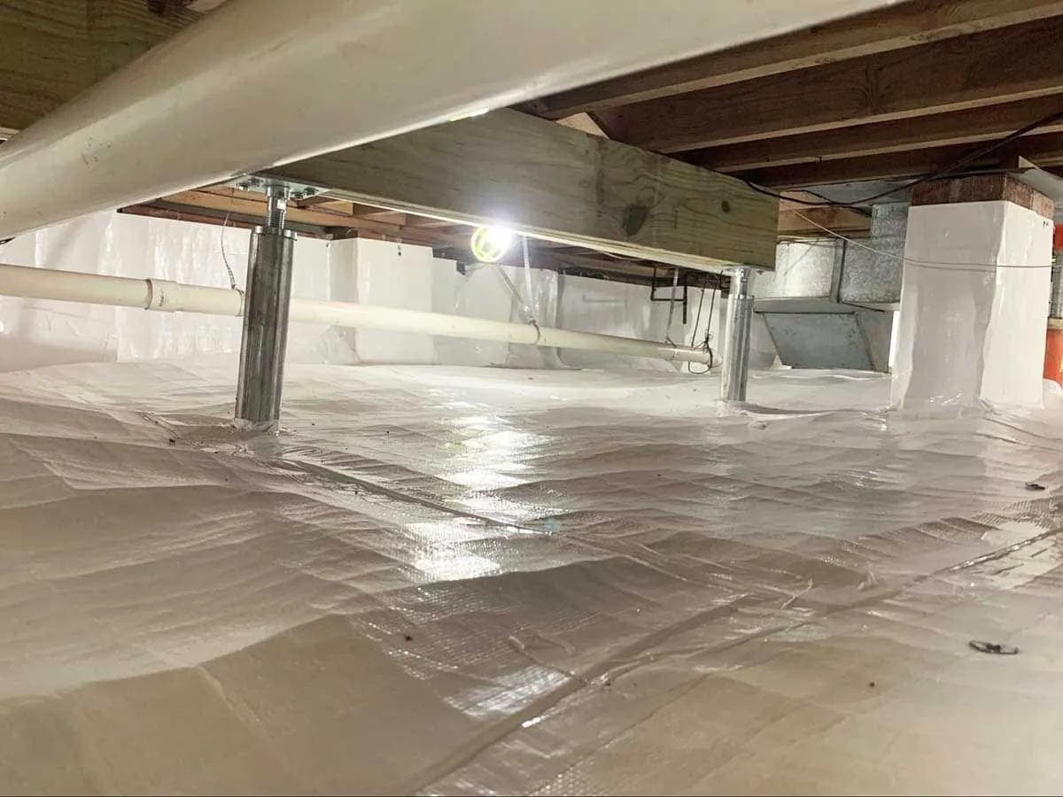 HydroHelp911 Crawl Space & Foundation Repair installing adjustable smart jacks and a vapor barrier in a crawl space.