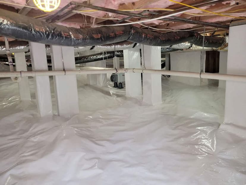 HydroHelp911 Crawl Space & Foundation Repair installing a white vapor barrier, dehumidifier, and insulation in a crawl space.