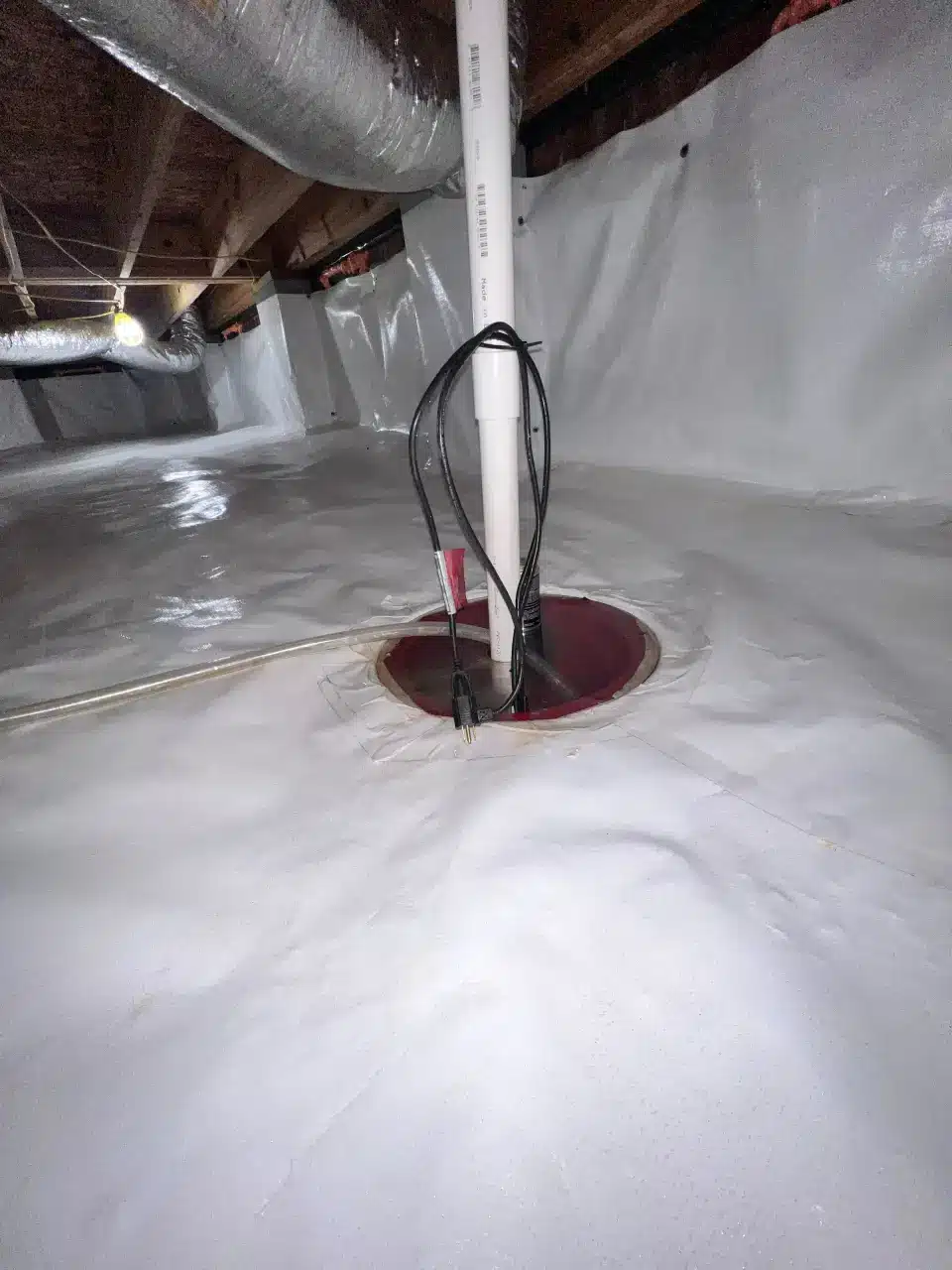 HydroHelp911 Crawl Space & Foundation Repair installing a sump pump and vapor barrier in an encapsulated crawl space.