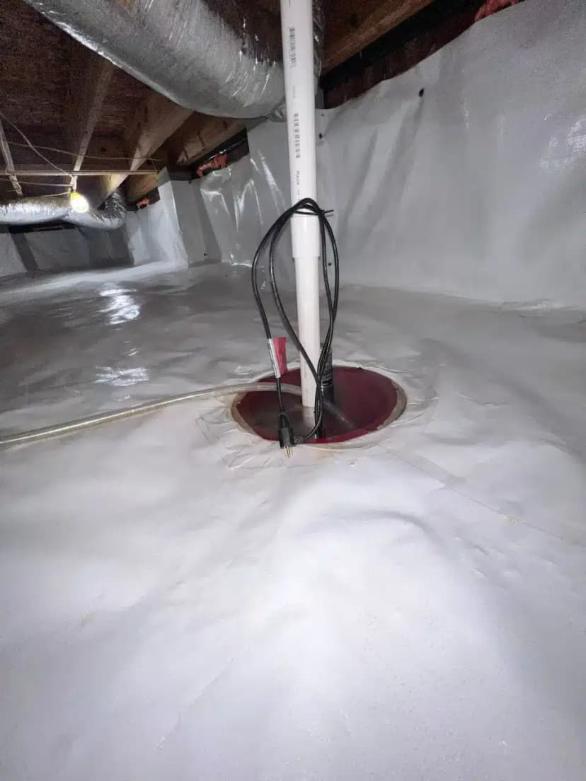 HydroHelp911 Crawl Space & Foundation Repair installing a sump pump and vapor barrier in an encapsulated crawl space.