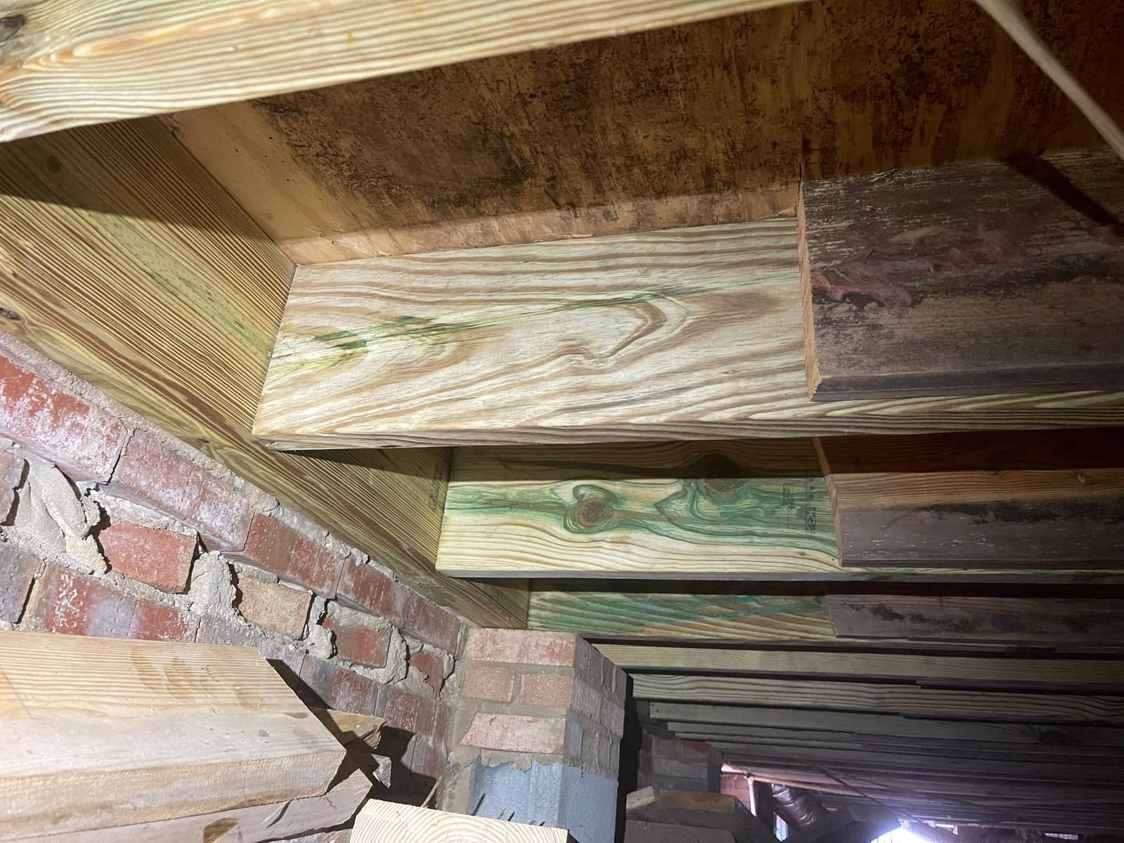 HydroHelp911 Crawl Space & Foundation Repair performing structural repair on rotted wood floor joists in a crawl space.