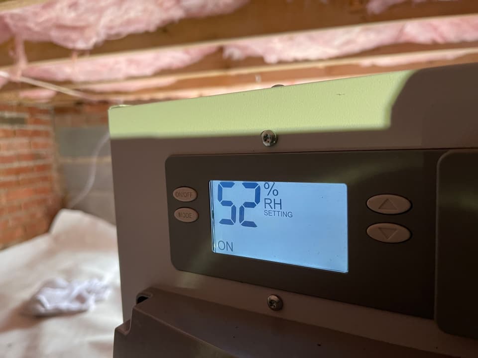 HydroHelp911 Crawl Space & Foundation Repair dehumidifier operating at 52% relative humidity setting in a crawl space.