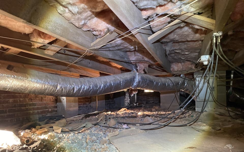 HydroHelp911 Crawl Space & Foundation Repair cleaning a Dallas crawl space with exposed earth