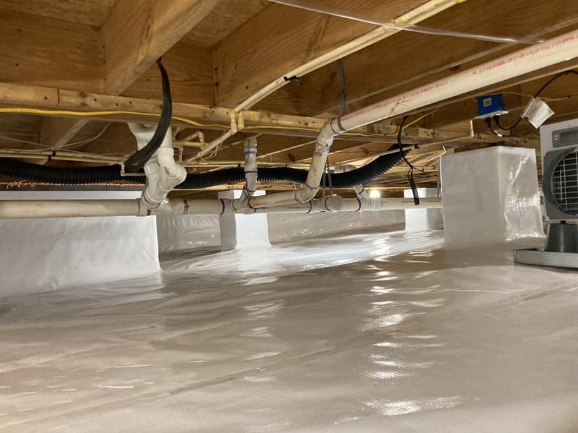 HydroHelp911 Crawl Space & Foundation Repair installing a vapor barrier and dehumidifier for encapsulation.