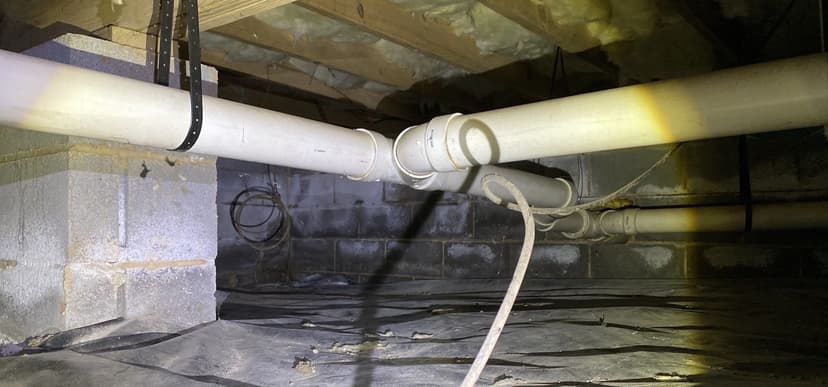 HydroHelp911 Crawl Space & Foundation Repair inspecting moisture on block foundation walls in a crawl space