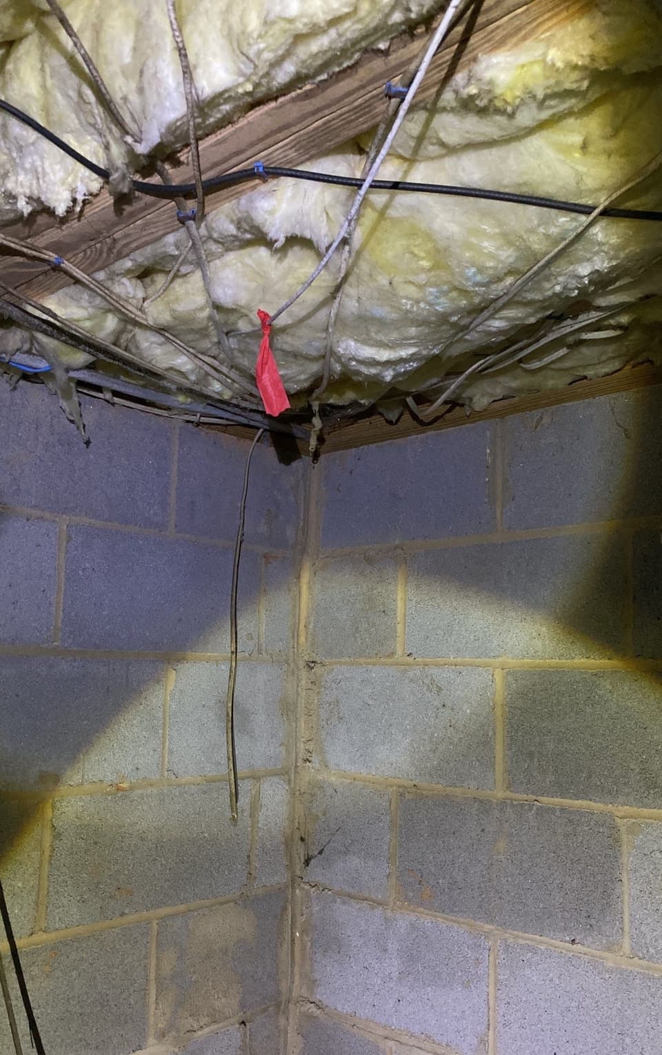 HydroHelp911 Crawl Space & Foundation Repair inspecting a cracked concrete block foundation wall