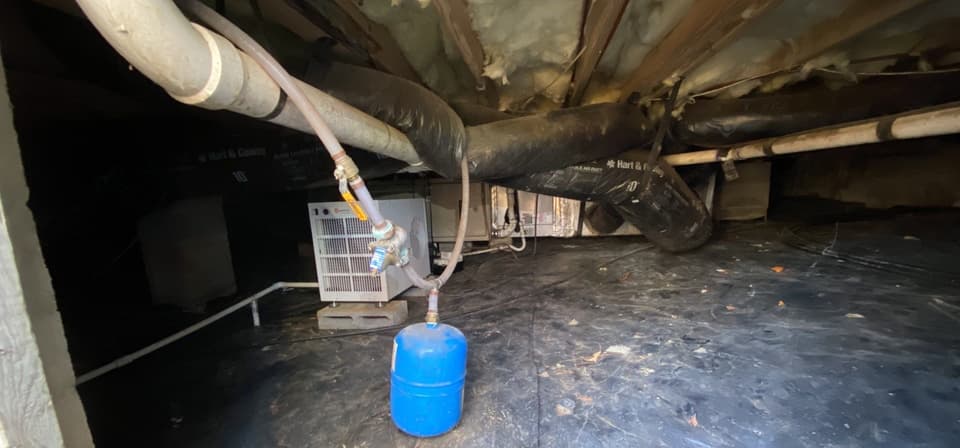 HydroHelp911 Crawl Space & Foundation Repair inspecting a crawl space with a dehumidifier and existing ground cover.