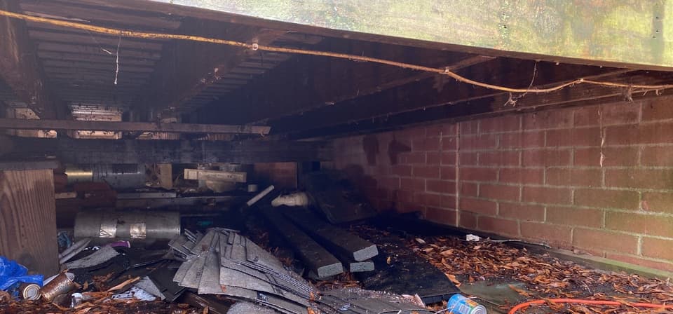 HydroHelp911 Crawl Space & Foundation Repair inspecting standing water, pooled water, and rotted wood in a dirty crawl space