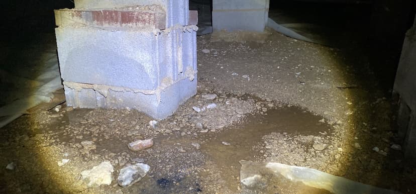 HydroHelp911 Crawl Space & Foundation Repair inspecting pooled water and high moisture in a crawl space.