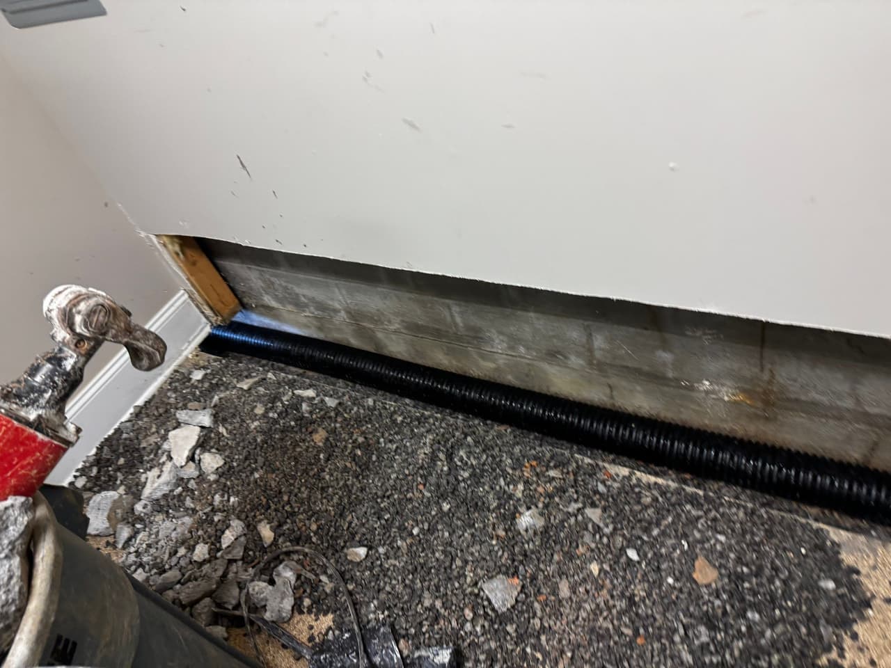 HydroHelp911 Crawl Space & Foundation Repair installing an interior drainage system in a basement.