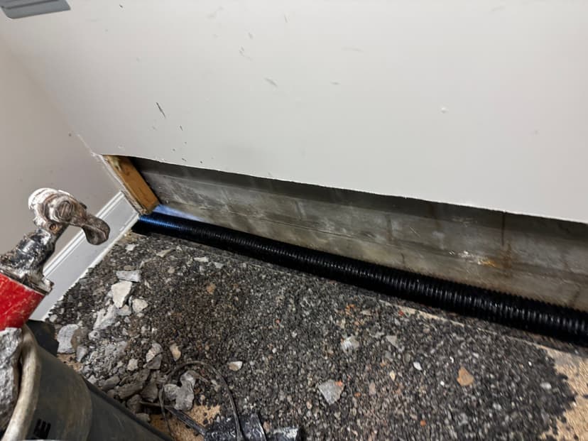 HydroHelp911 Crawl Space & Foundation Repair installing an interior drainage system in a basement.