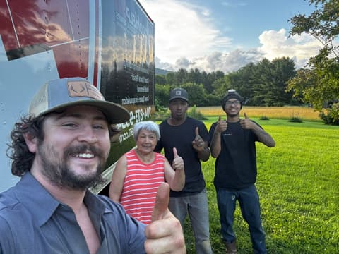 HydroHelp911 Crawl Space & Foundation Repair crew and a customer giving thumbs up signs beside a branded truck.