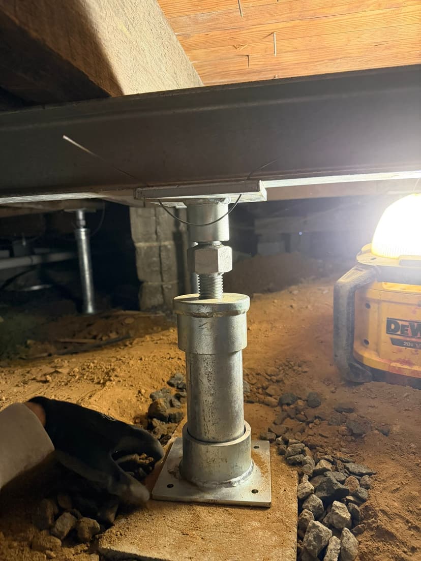 HydroHelp911 Crawl Space & Foundation Repair installing adjustable crawl space jacks and a steel I-beam.