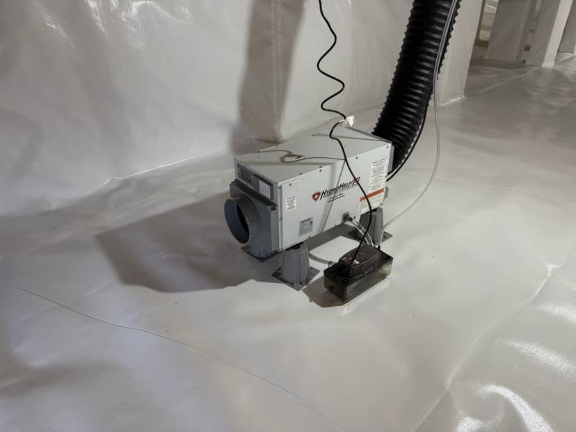 HydroHelp911 Crawl Space & Foundation Repair installing a dehumidifier and vapor barrier in an encapsulated crawl space.