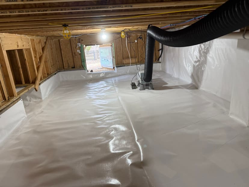 HydroHelp911 Crawl Space & Foundation Repair installing a white vapor barrier, dehumidifier, and ductwork in a crawl space.