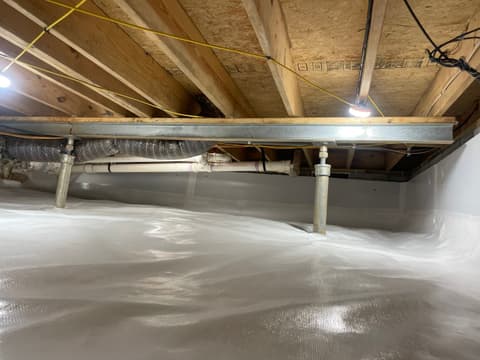 HydroHelp911 Crawl Space & Foundation Repair installing a vapor barrier and adjustable steel jacks in a crawl space.