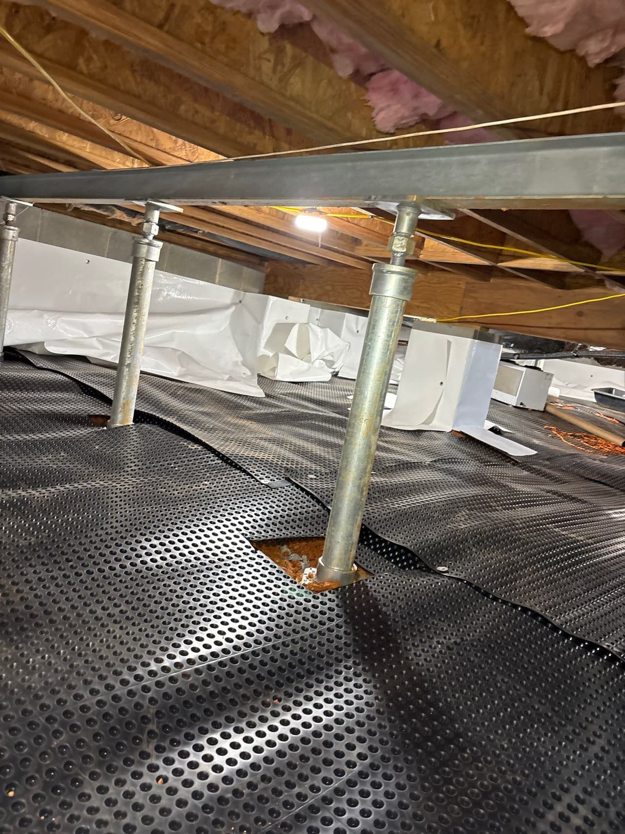 HydroHelp911 Crawl Space & Foundation Repair installing adjustable steel jacks for crawl space structural repair.