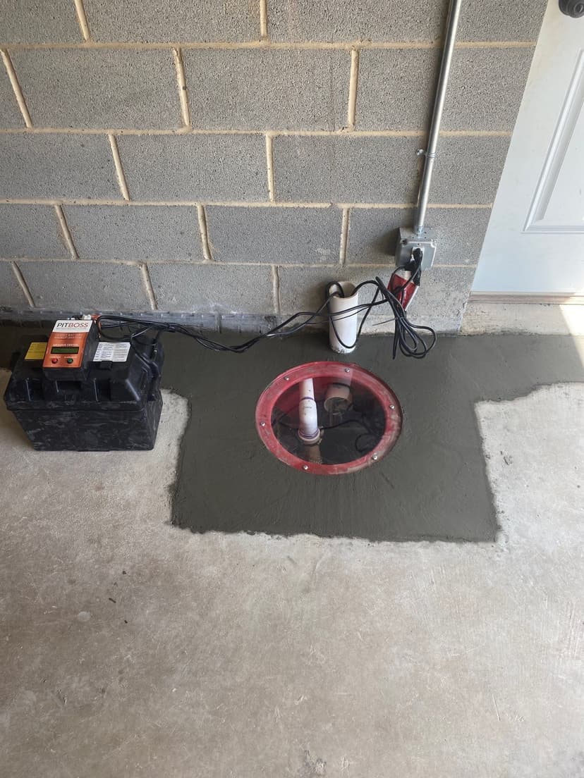 HydroHelp911 Crawl Space & Foundation Repair installing a new PitBoss battery backup sump pump system in a basement.