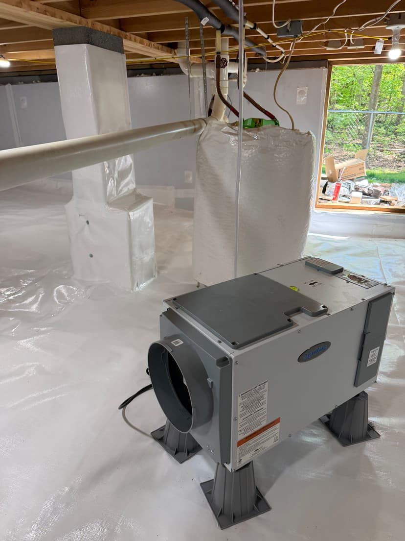 HydroHelp911 Crawl Space & Foundation Repair installing a dehumidifier in a fully encapsulated crawl space.