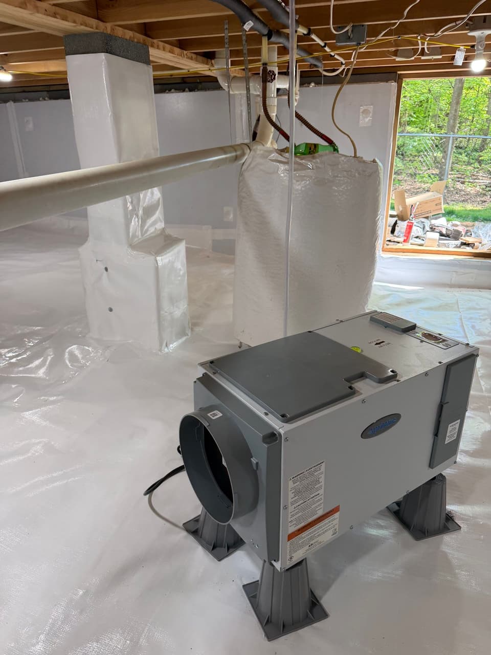 HydroHelp911 Crawl Space & Foundation Repair installing a dehumidifier in a fully encapsulated crawl space.