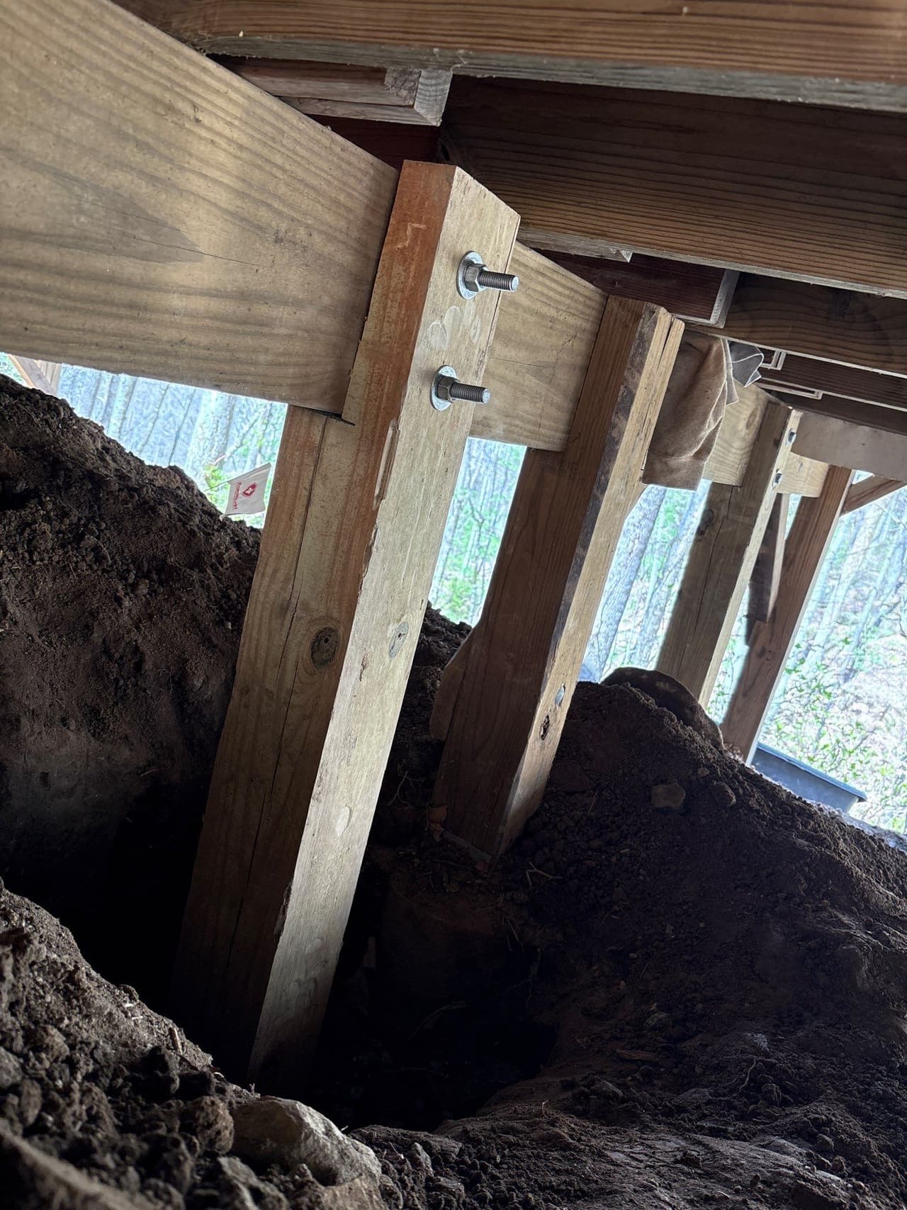 HydroHelp911 Crawl Space & Foundation Repair replacing wooden support beams and piers under a home.