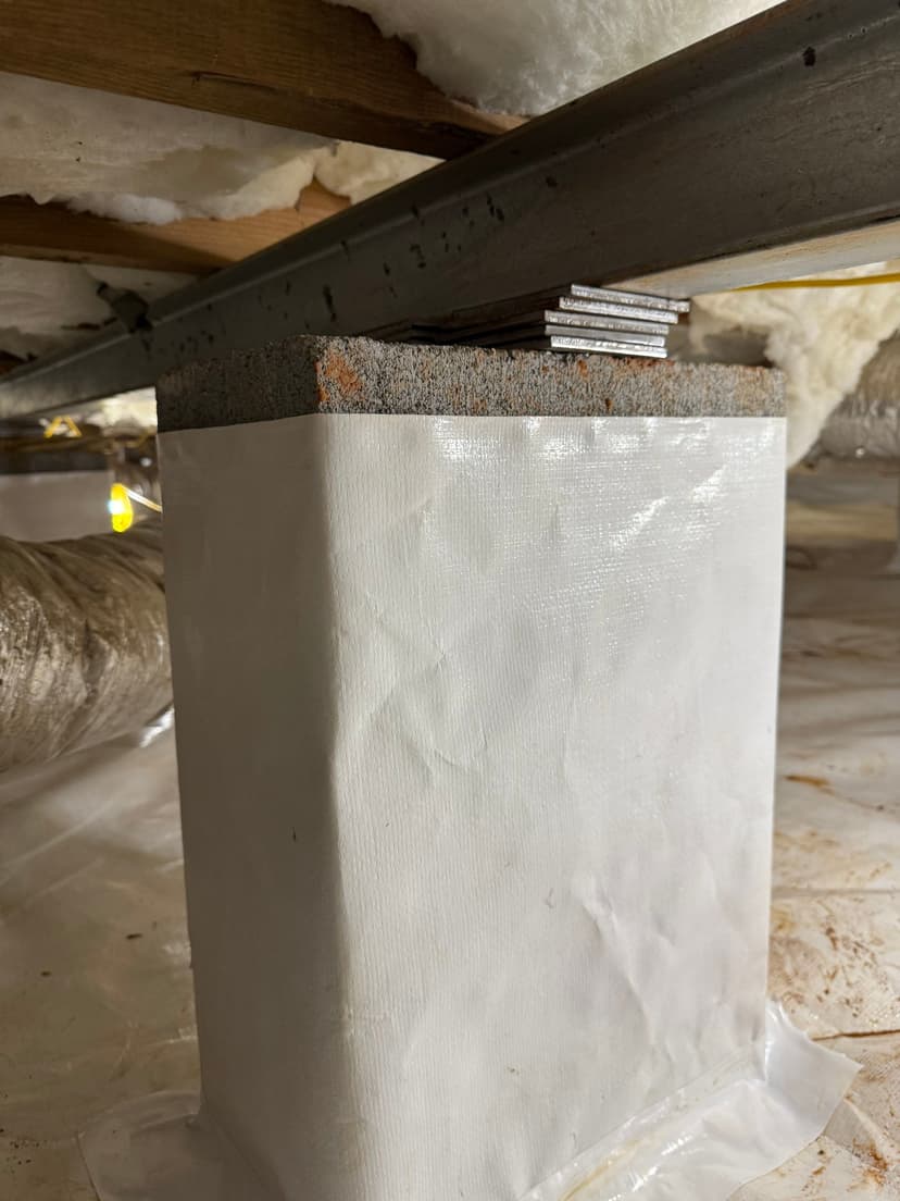 HydroHelp911 Crawl Space & Foundation Repair encapsulating a crawl space pier with a durable vapor barrier.