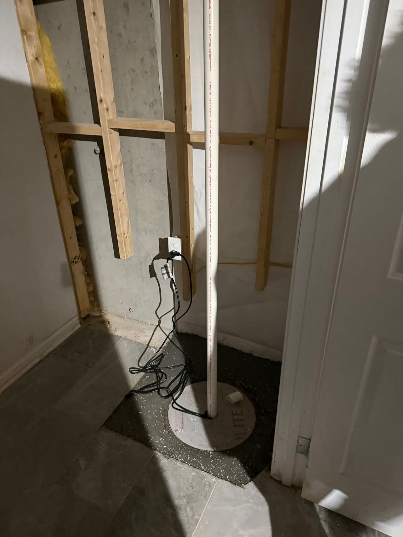 HydroHelp911 Crawl Space & Foundation Repair installing a new sump pump as part of a basement interior drainage system.