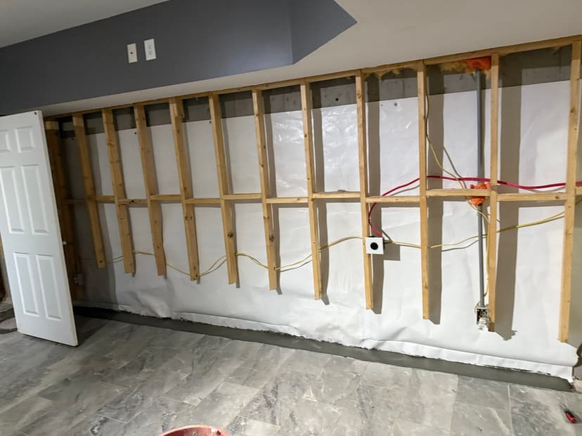 HydroHelp911 Crawl Space & Foundation Repair installing an interior drainage system and vapor barrier