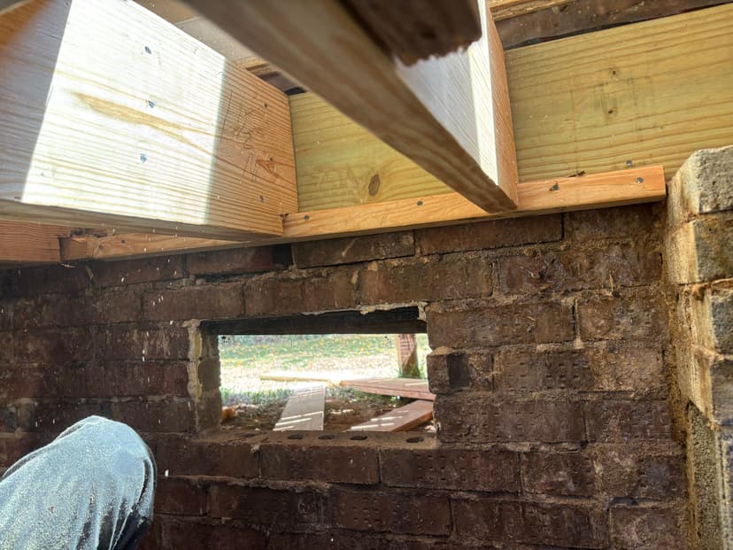 HydroHelp911 Crawl Space & Foundation Repair installing new wooden floor joists in a crawl space.