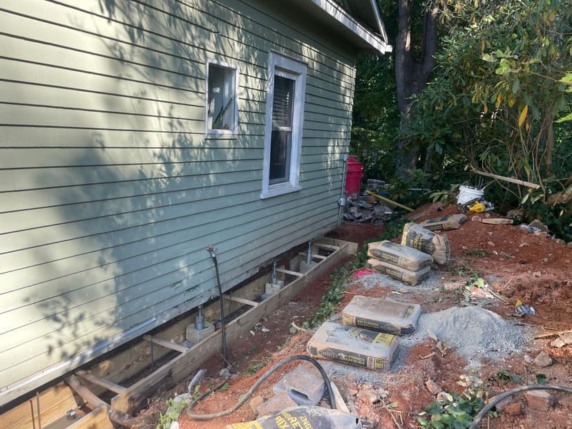 HydroHelp911 Crawl Space & Foundation Repair installing crawl space support jacks and wood framing.