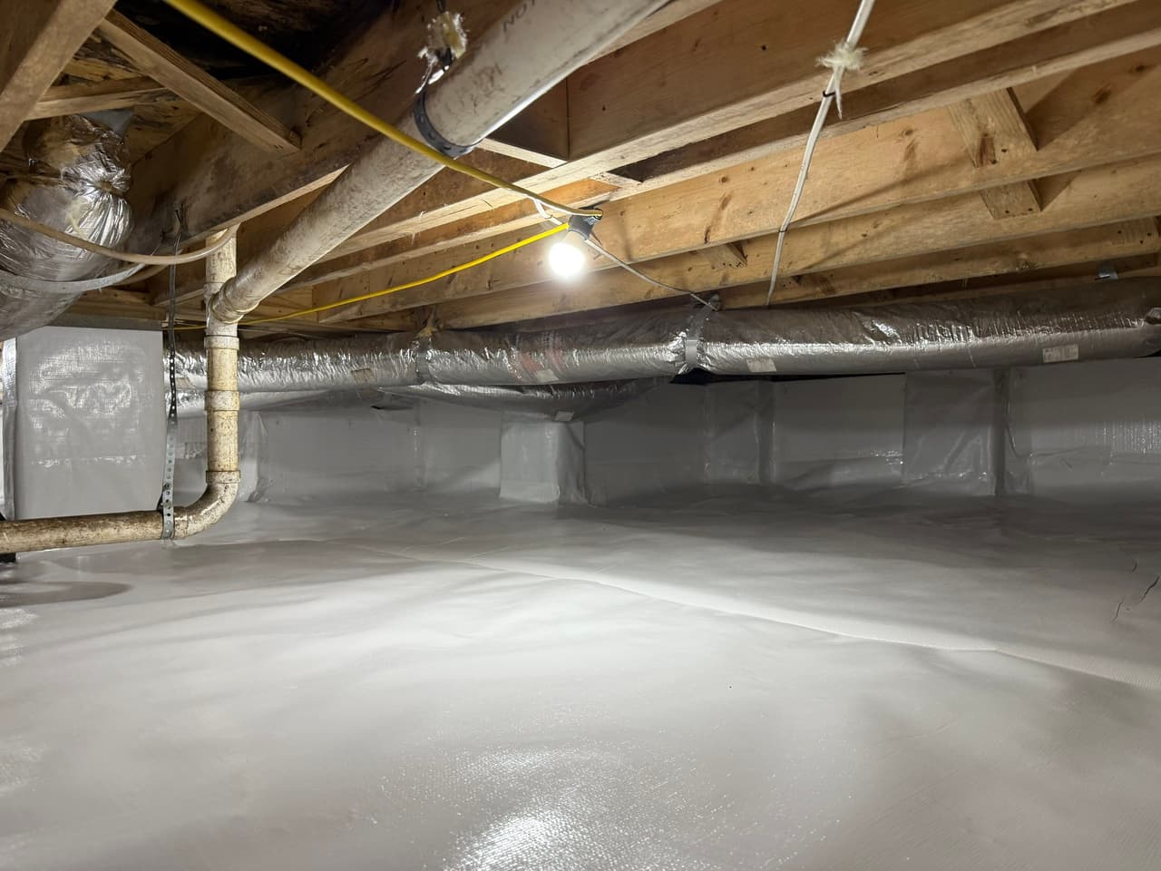 HydroHelp911 Crawl Space & Foundation Repair completed a crawl space encapsulation with a white vapor barrier liner.