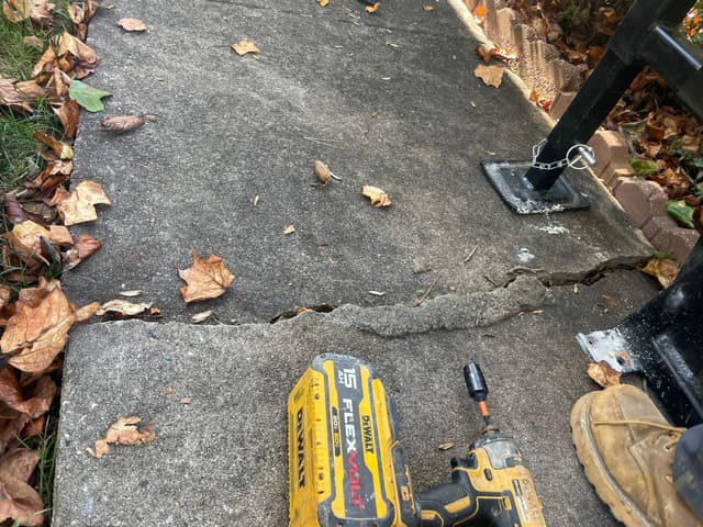 HydroHelp911 Crawl Space & Foundation Repair inspecting cracked concrete and uneven concrete slabs, a tripping hazard