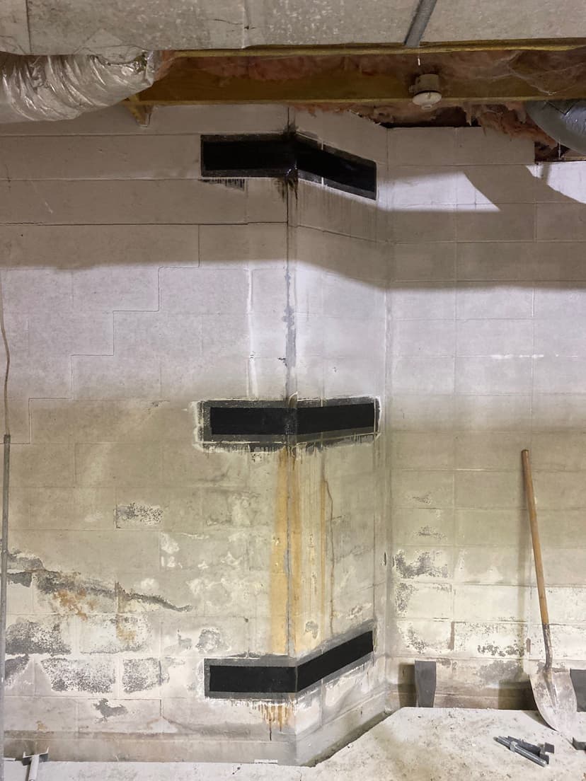 HydroHelp911 Crawl Space & Foundation Repair applying carbon fiber reinforcement to a bowing basement wall