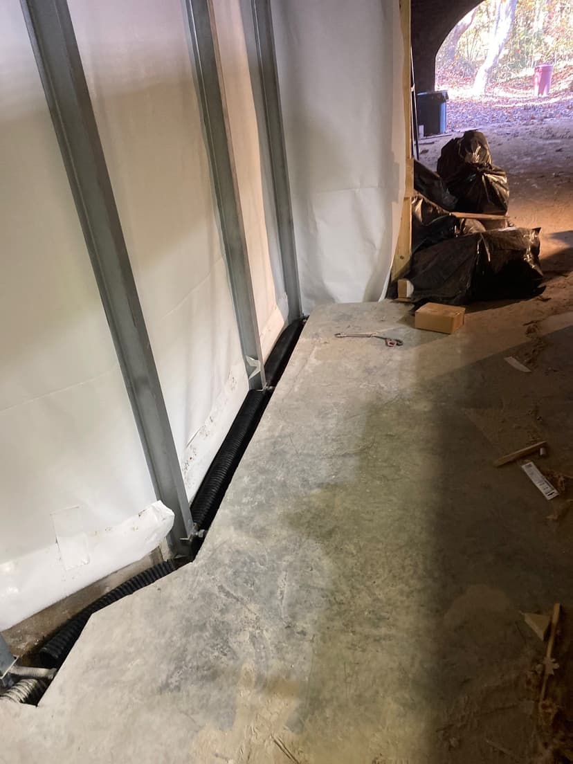 HydroHelp911 Crawl Space & Foundation Repair installing an interior drainage system and vapor barrier.