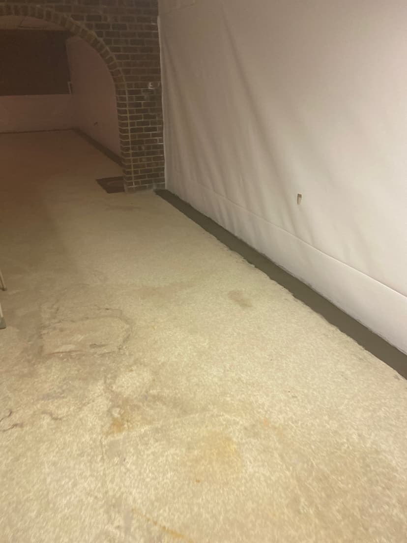 HydroHelp911 Crawl Space & Foundation Repair installing an interior drainage system and basement vapor barrier.