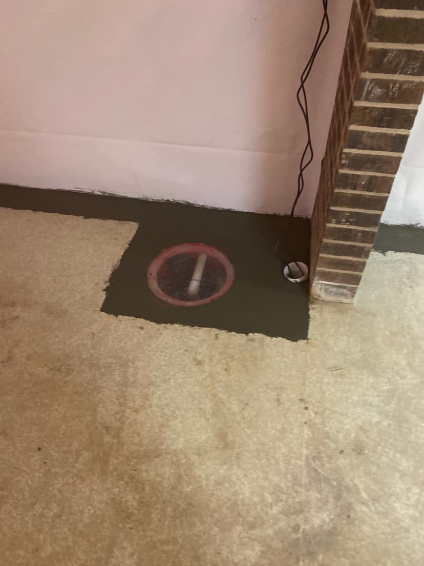 HydroHelp911 Crawl Space & Foundation Repair installing a sump pump and interior drainage system in a basement.