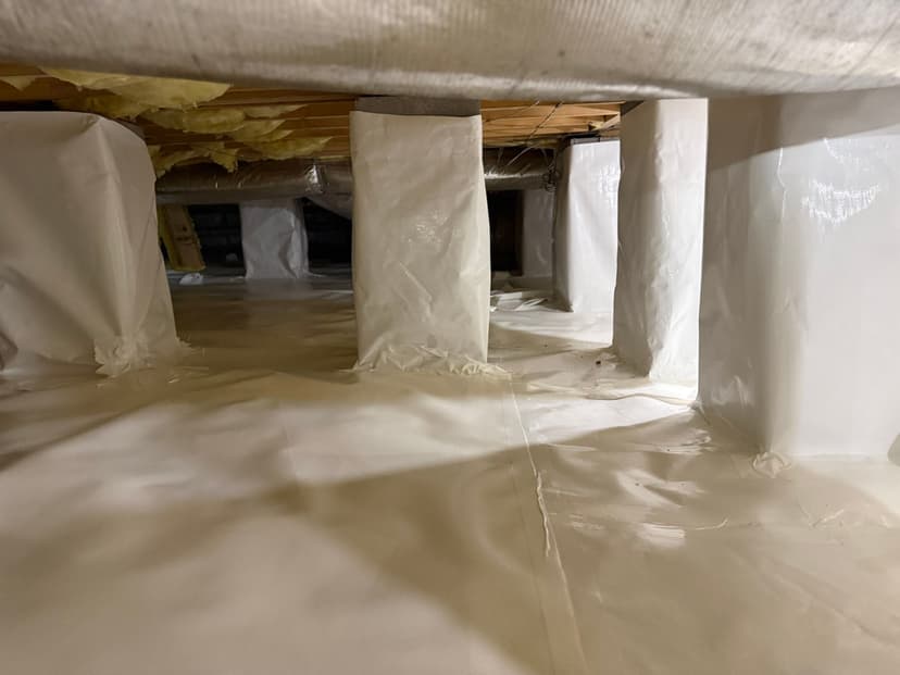 HydroHelp911 Crawl Space & Foundation Repair installing a white reinforced vapor barrier for full encapsulation.