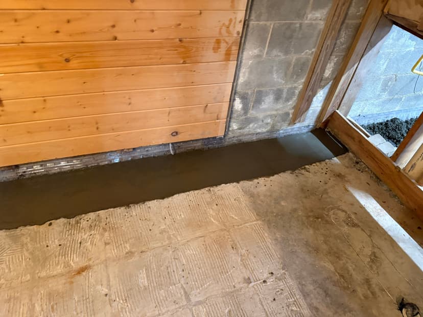 HydroHelp911 Crawl Space & Foundation Repair installing an interior drainage system in a basement.