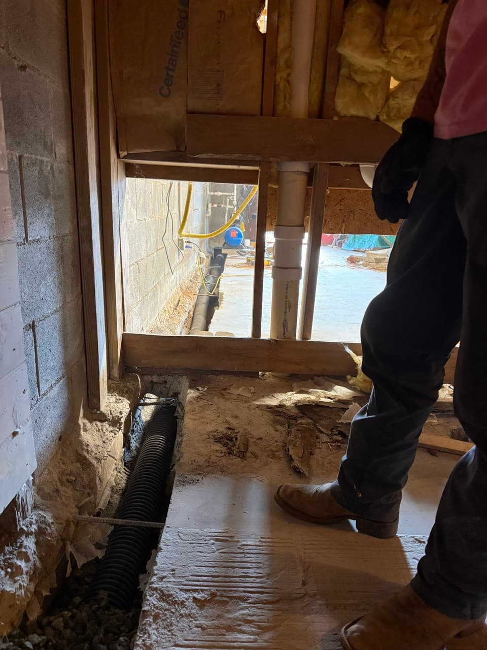 HydroHelp911 Crawl Space & Foundation Repair installing a basement waterproofing interior drainage system