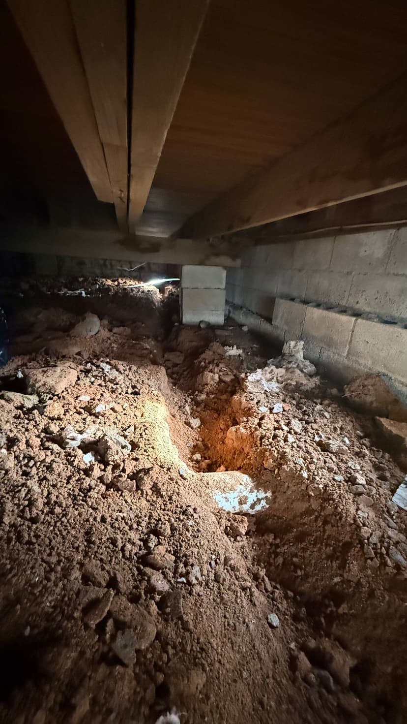 HydroHelp911 Crawl Space & Foundation Repair installing a drainage system in a damp crawl space.