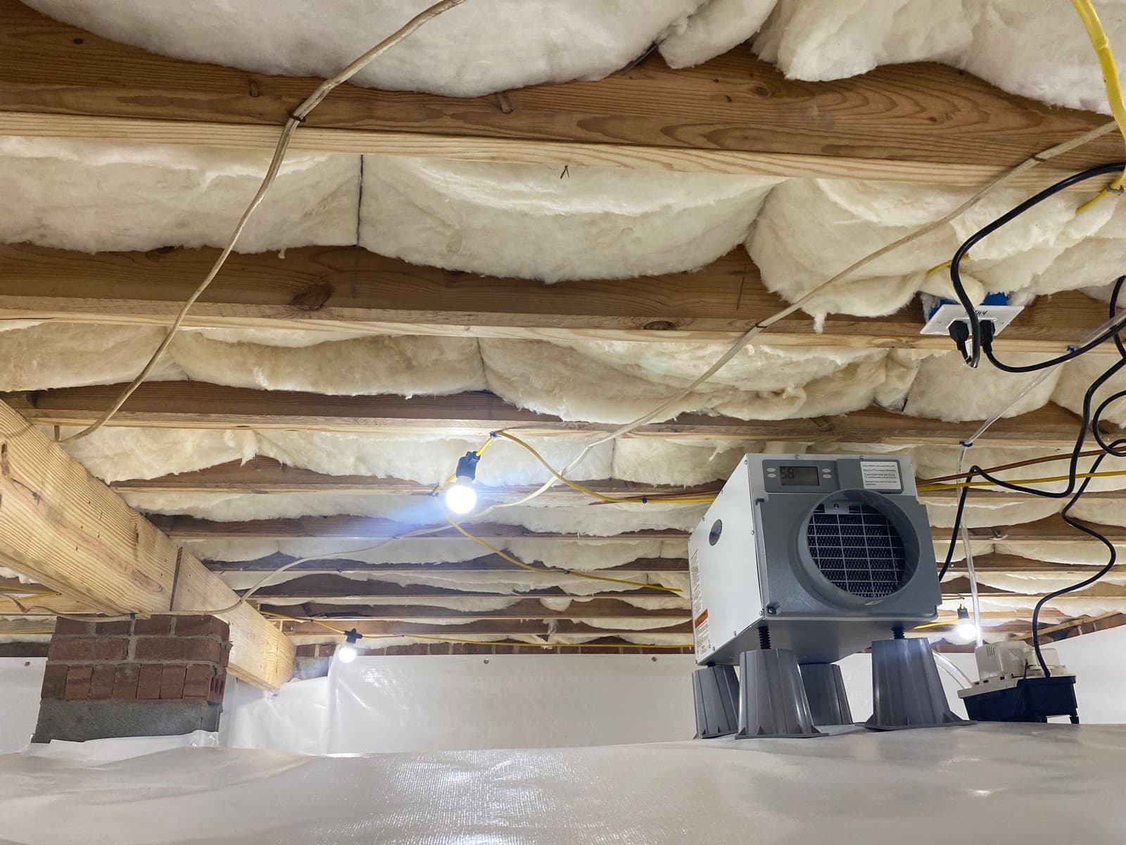 HydroHelp911 Crawl Space & Foundation Repair installing a crawl space encapsulation system with a dehumidifier